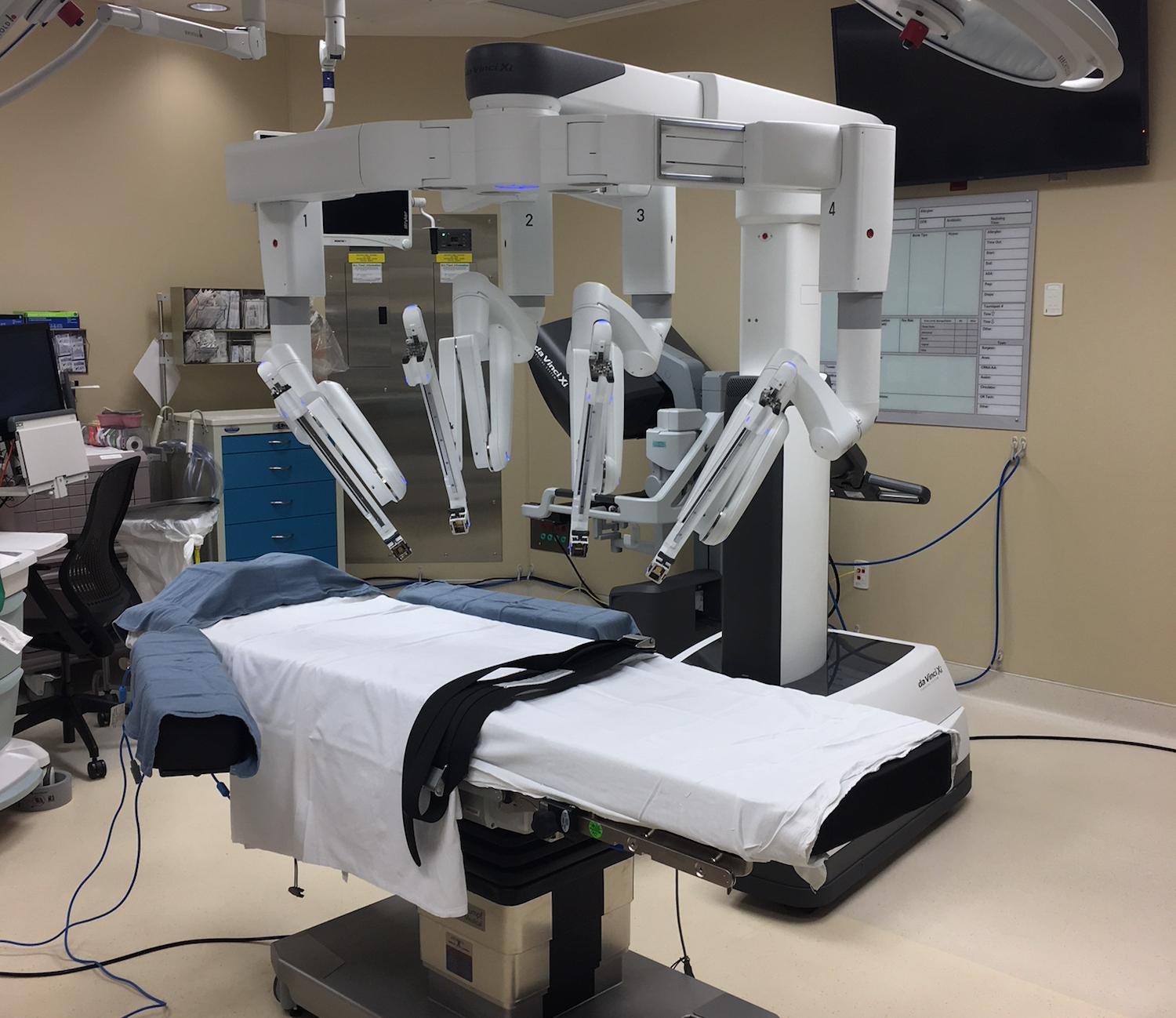 Medical robotic surgical system with an adjustable operating table in a hospital room.