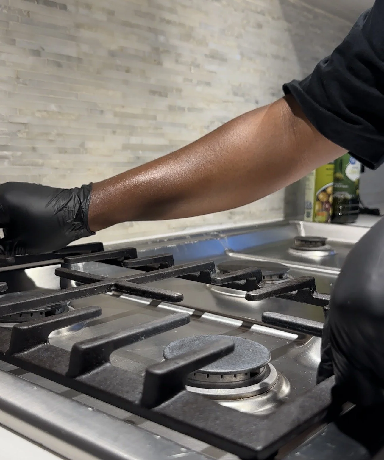 Love in a Bucket professional cleaning kitchen services on  stainless steel gas stove with three burners, adjusting burners