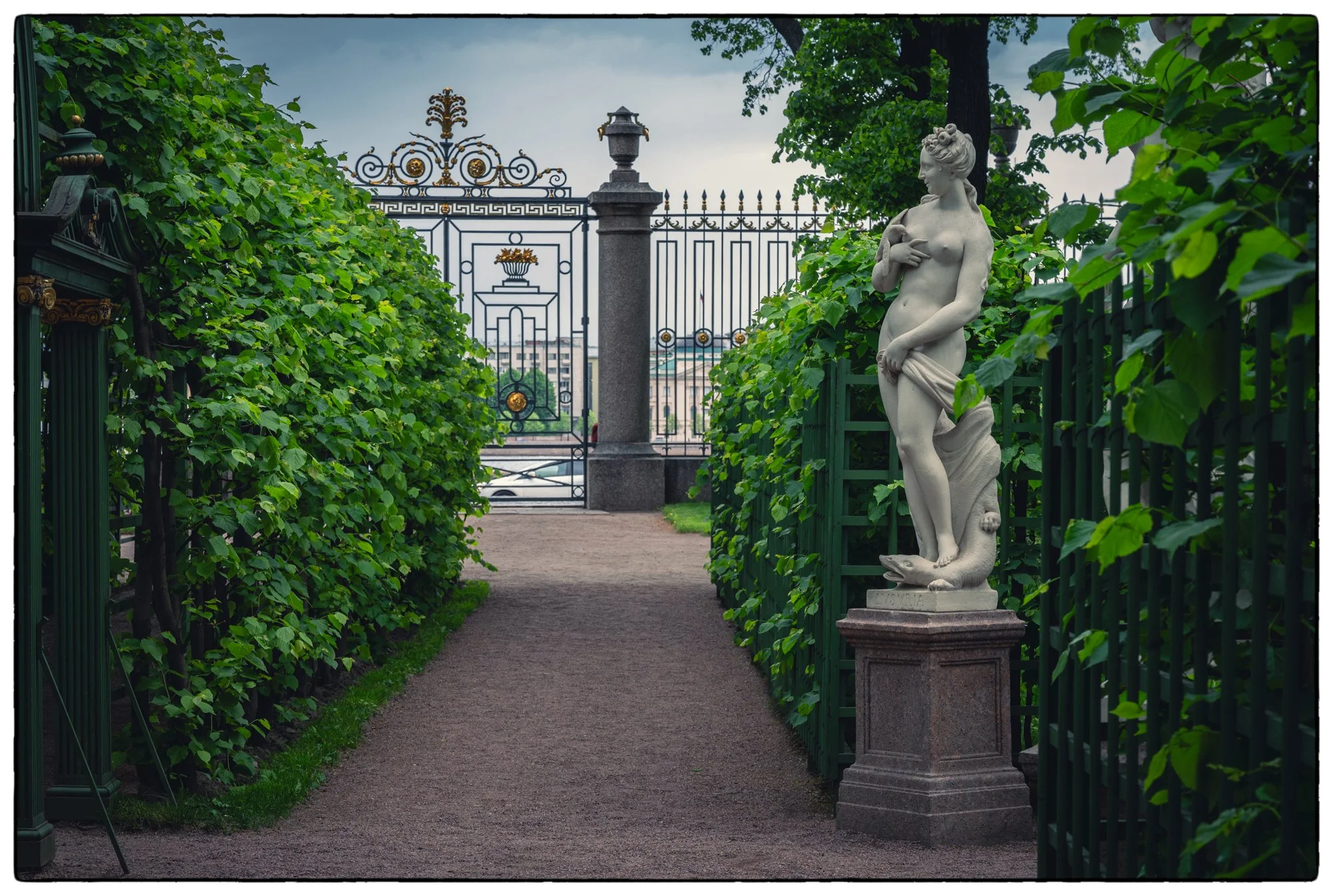 Summer Garden. Beautiful park with old trees, flower beds, fountains, Greek Statures and elegant cottages where one can buy a cup of coffee, seat at the table and watch well dressed city folks walking the alleys