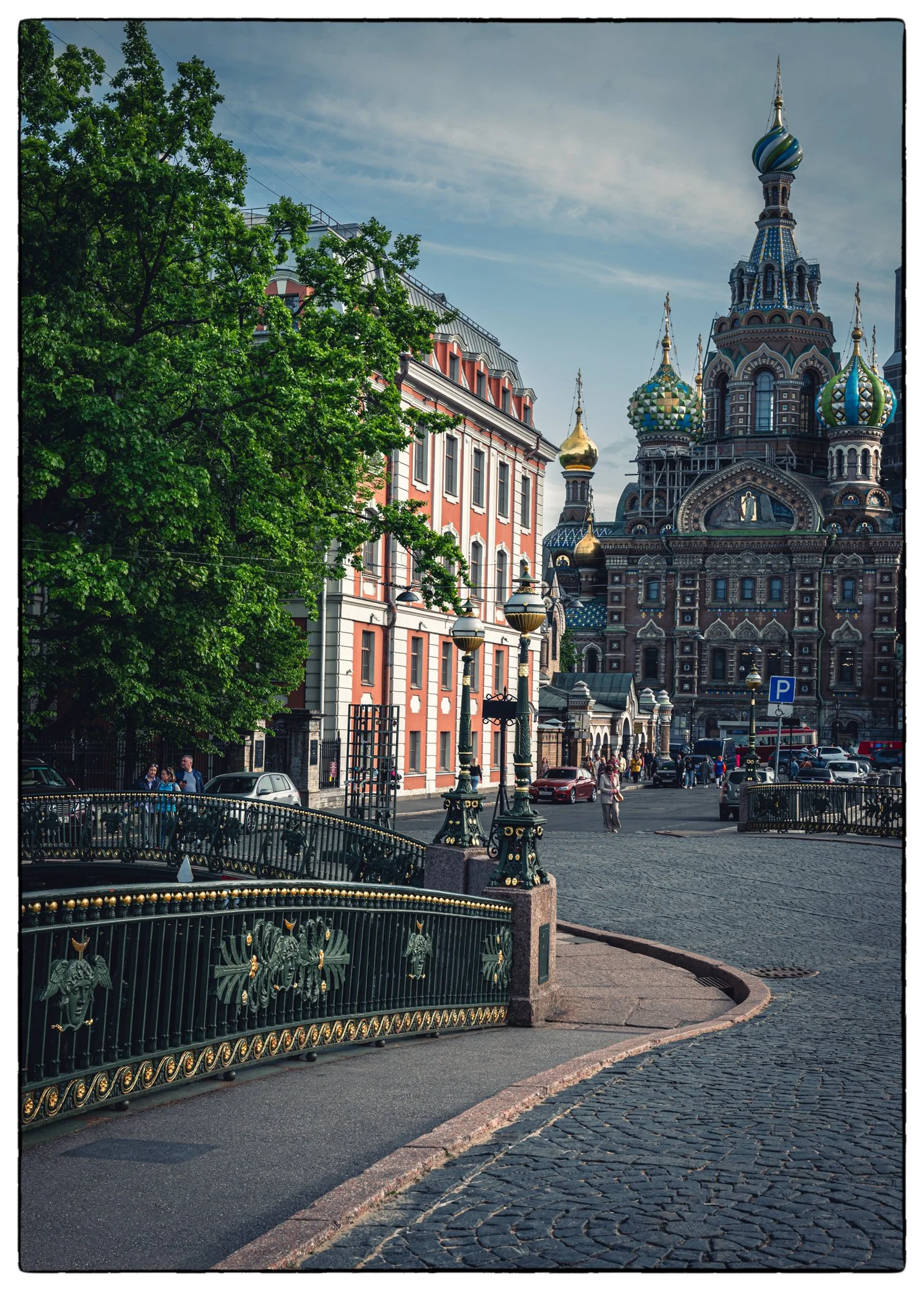 This is an interesting spot, two bridges join each other in the shape of "T"  on a joint of River Moyka and Canal Griboyedova with the Savior on the Blood church on the backdrop