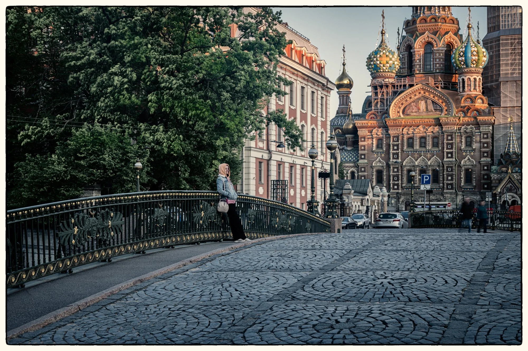 This is an interesting spot, two bridges join each other in the shape of "T"  on a joint of River Moyka and Canal Griboyedova with the Savior on the Blood church on the backdrop.