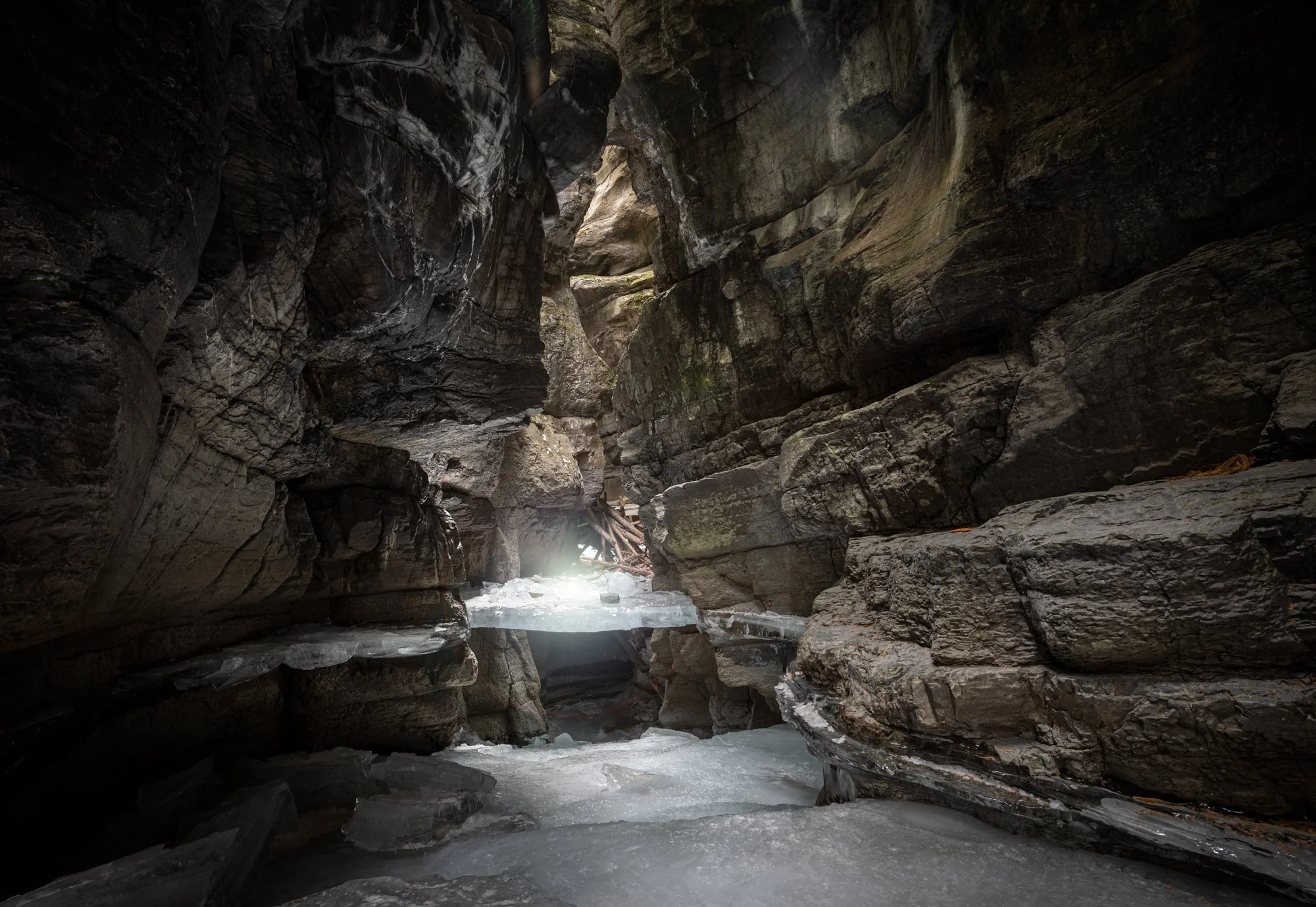 Maligne Canyon. Late, around 5 PM this part of the canyon was very dark. And yet we had some light passing through.