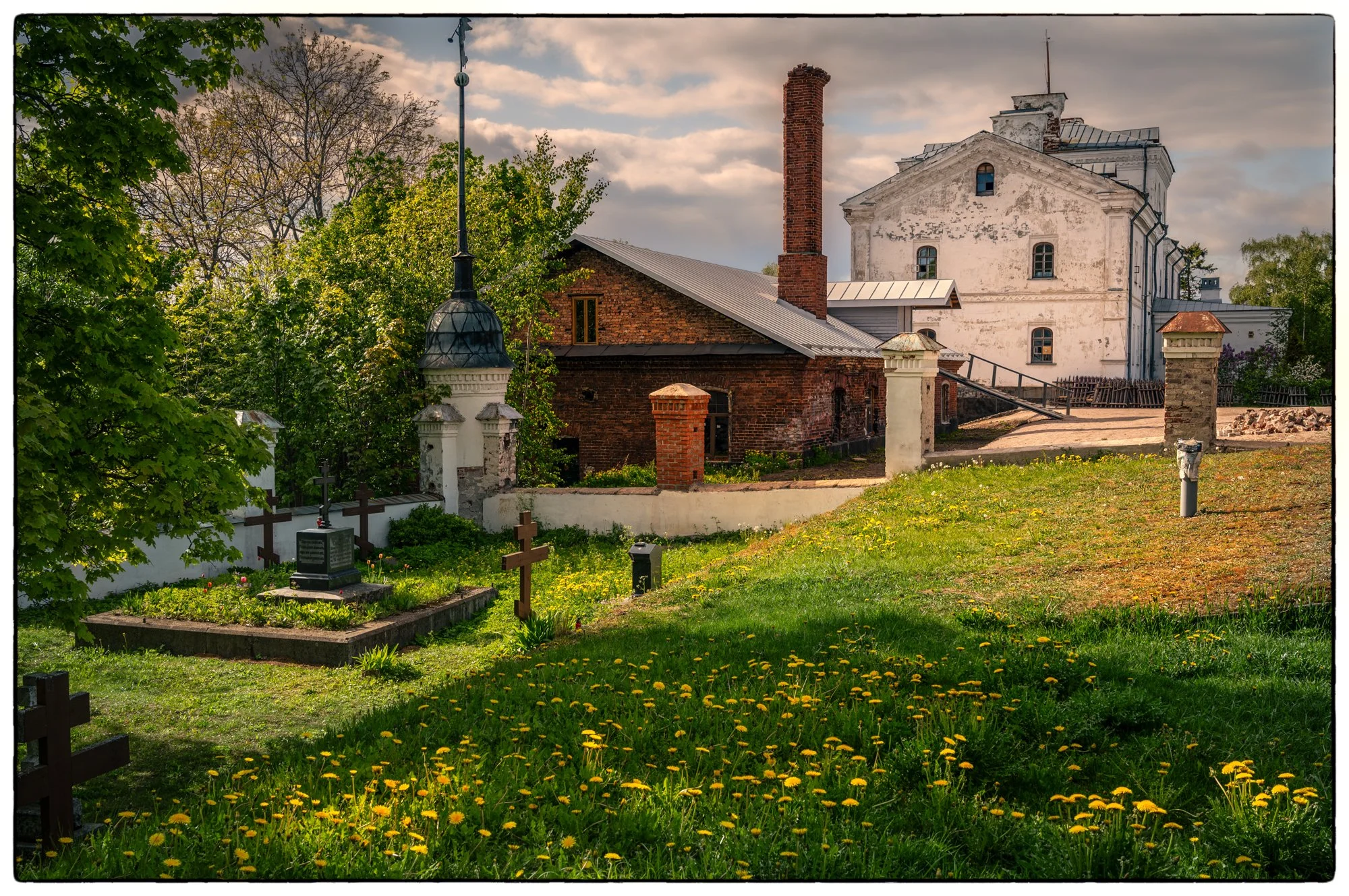Monastery on the island. Old cemetery and utility buildings on the back of the monastery.