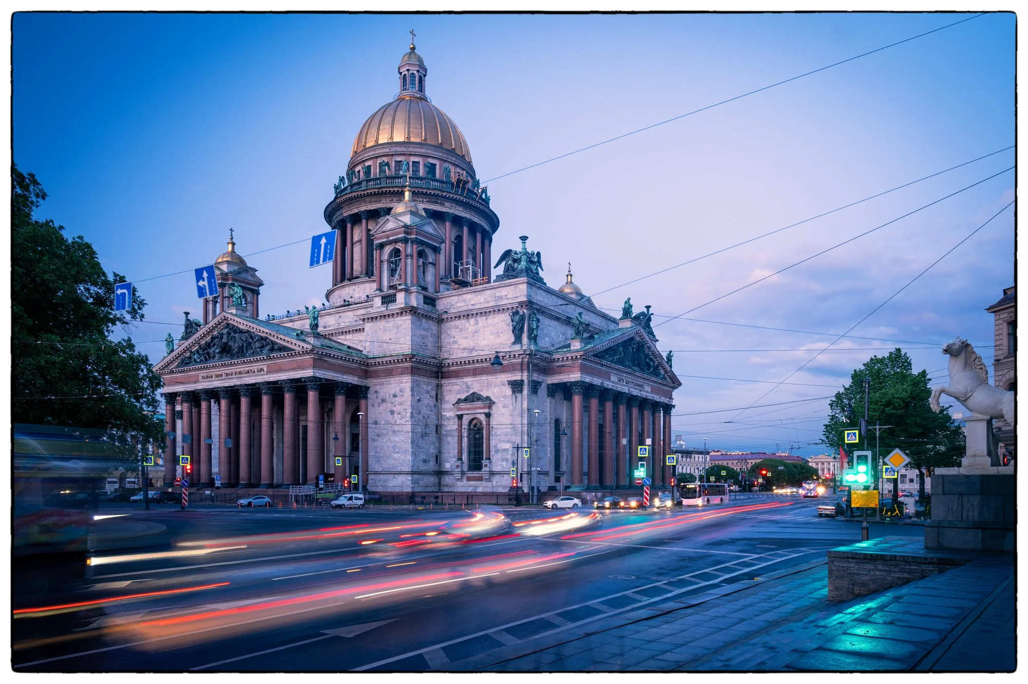 The St. Isaac Cathedral in the evening, the photo was taken from the steps of the Manege Building using tripod to see how the cars' lights were trailed as the cars were going by. Looks cool, isn't it?