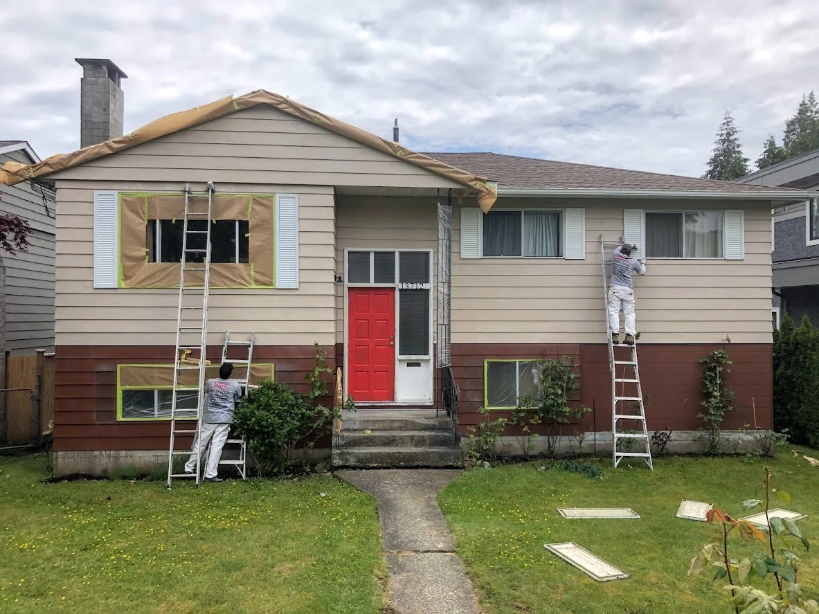After pressure washing, we are masking off the windows to prep for spraying!