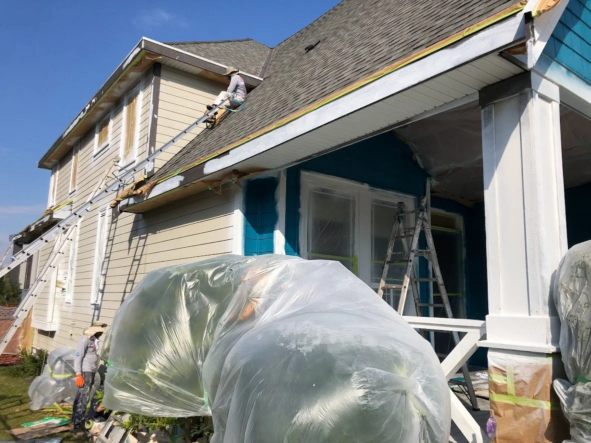 After spraying the trim, we are spraying the siding blue!