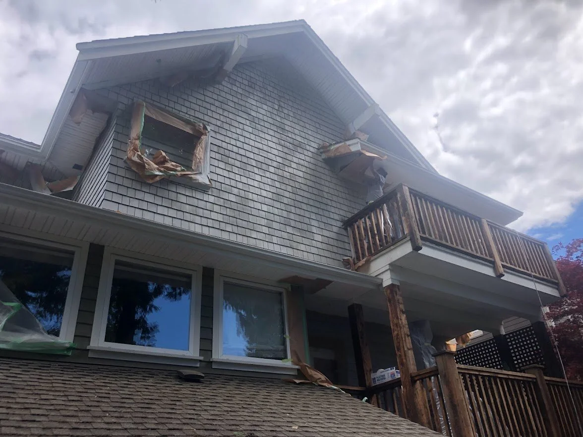 After spraying the siding / shingles, before spraying the railings / spindles!