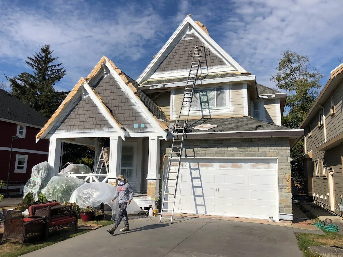 After prep, we sprayed a coat on the trim and garage door before we start spraying the siding & shakes!