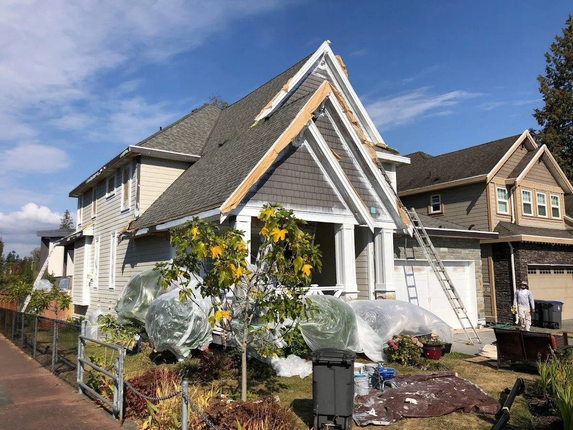 After prep, we sprayed a coat on the trim and garage door before we start spraying the siding & shakes!
