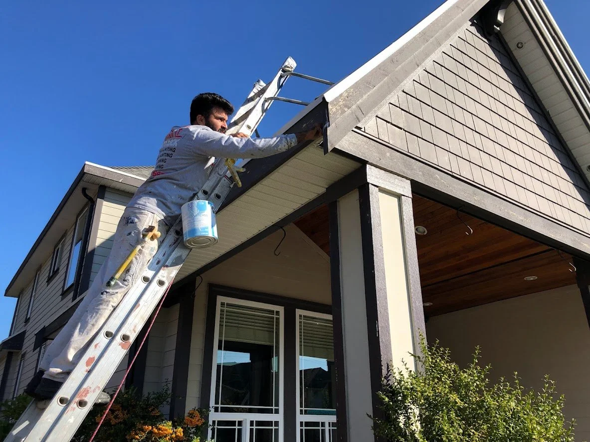 After pressure washing, prepping the house before masking and spraying the paint!
