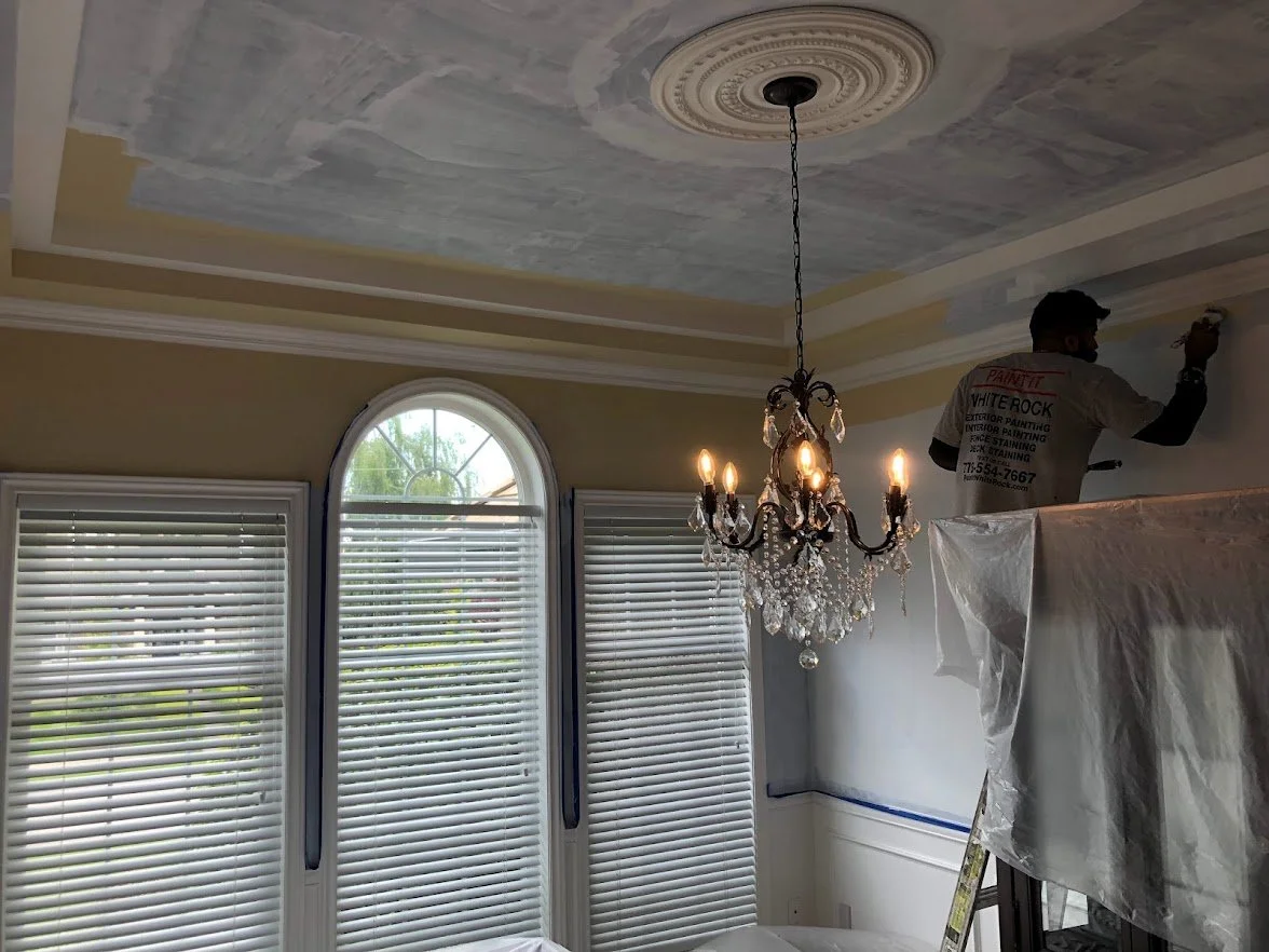 We had painted the crown molding and are cutting in the ceiling and walls here!