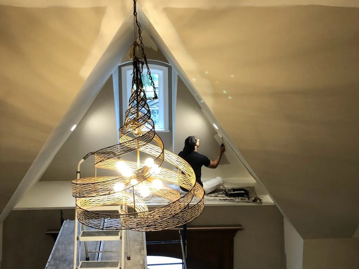After covering the hardwood floors we brought scaffolding in to reach this cathedral ceiling, and we are painting the walls a fresh new colour!