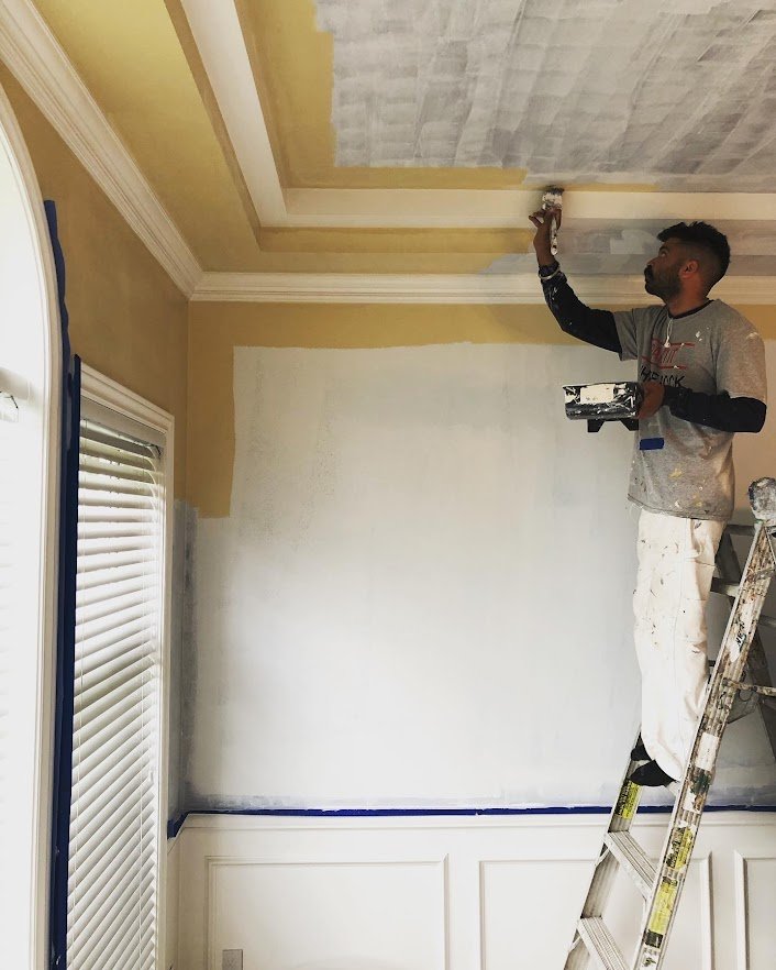 We had painted the crown molding and are cutting in the ceiling and walls here!