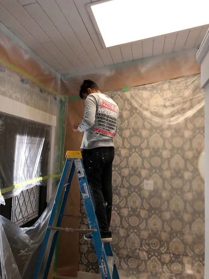 After spraying the ceilings with oil primer to block bleed through, we are removing the masking.