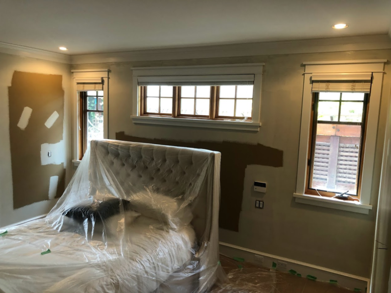 After we covered the floors and the furniture, we have cut in the walls and are now rolling out the first coat on the walls!