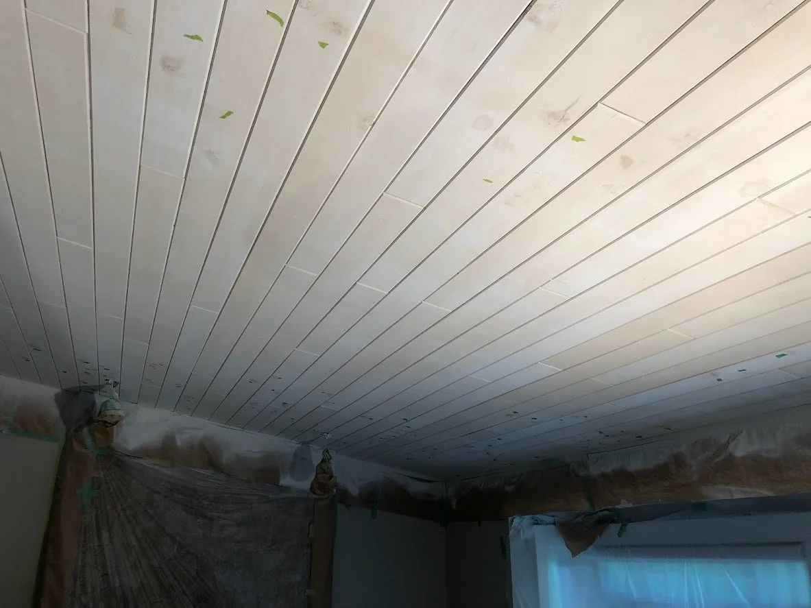 After spraying the first coat of oil primer. You can see the stain is still bleeding through, and we have marked spots where we are filling in holes before we spray the second coat of oil primer!