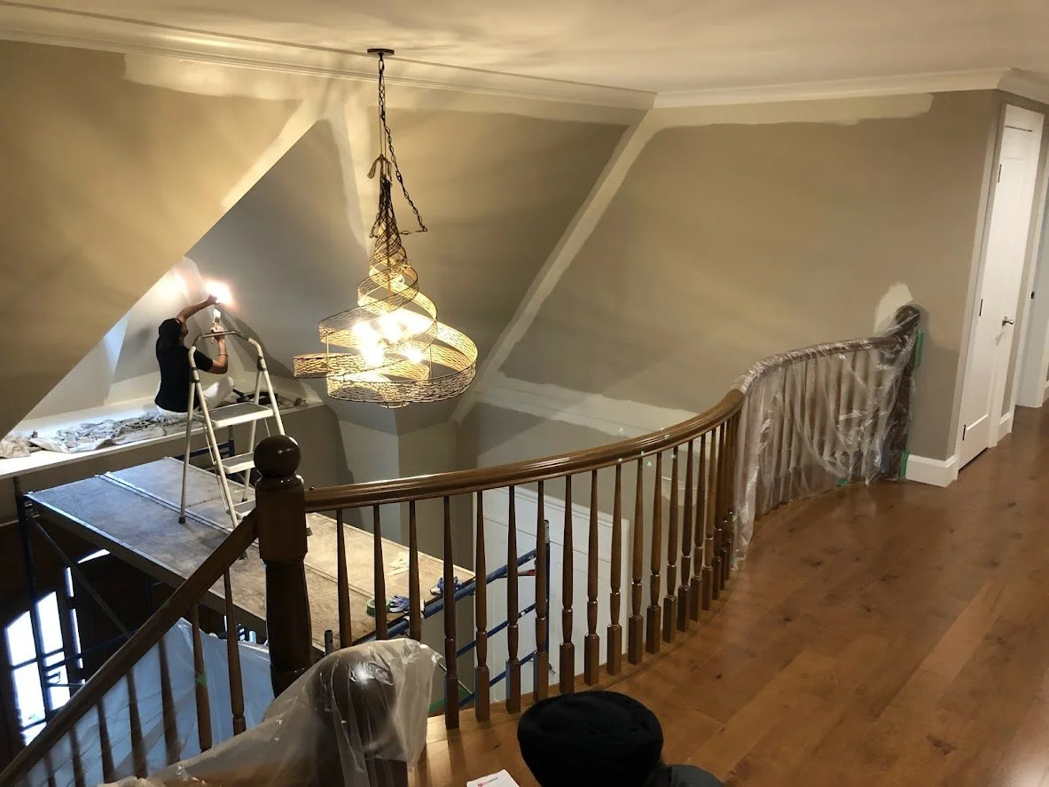 After covering the hardwood floors we brought scaffolding in to reach this cathedral ceiling, and we are painting the walls a fresh new colour!