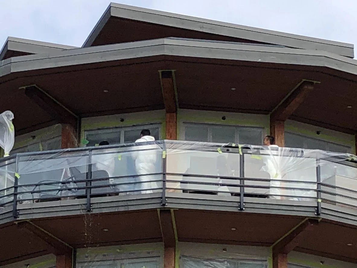 Applying stripper onto the glulams / pillars / posts to remove the previous varnish coat.