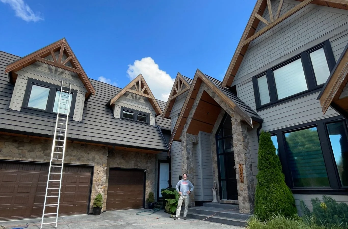 A skilled Paint It White Rock painter applying premium-quality paint to a home in Morgan Creek, BC, showcasing the benefits of expert painting services.