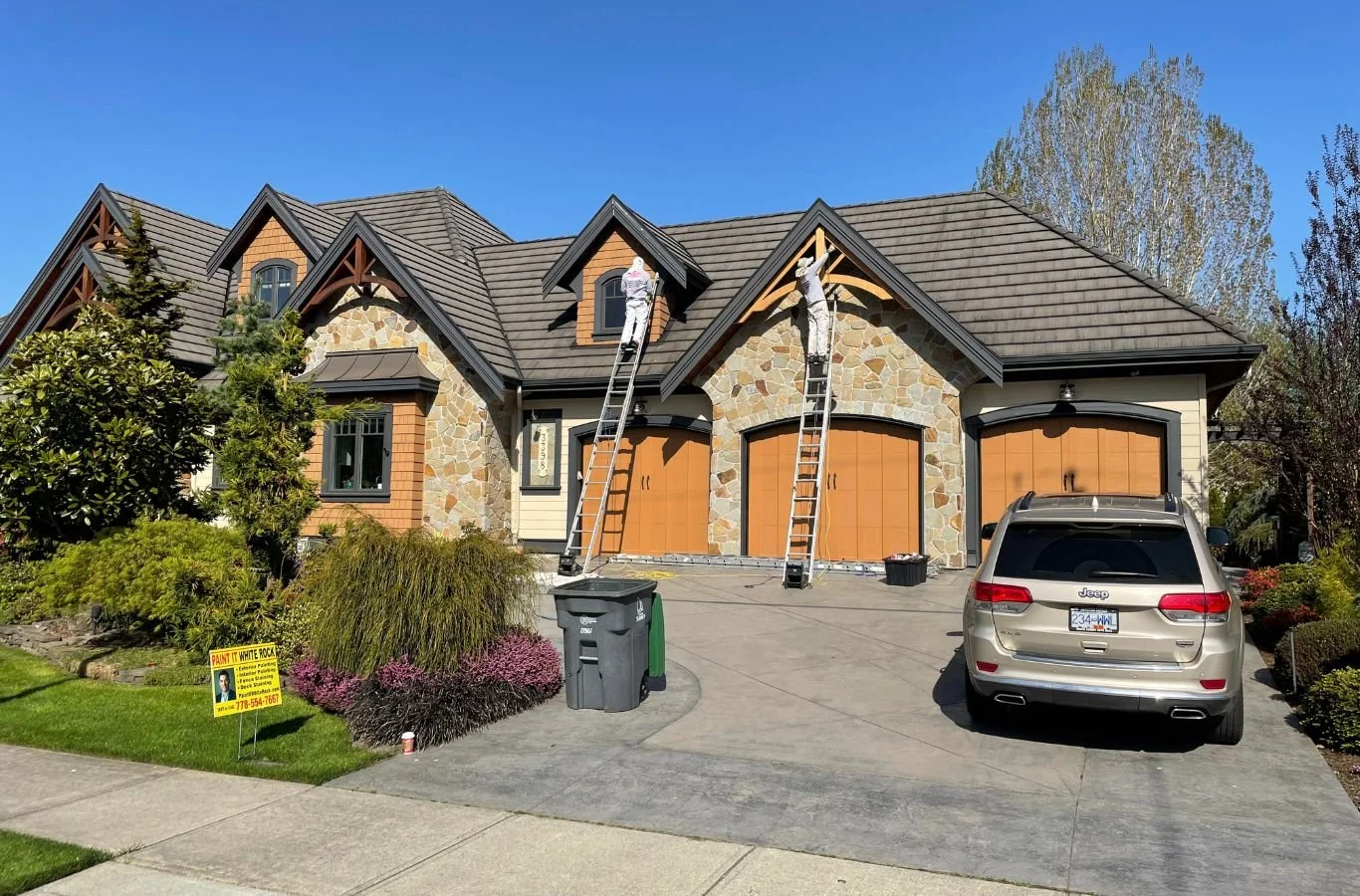 A satisfied customer in Morgan Creek, BC admiring the perfectly painted walls completed by Paint It White Rock. Painting Company near me.