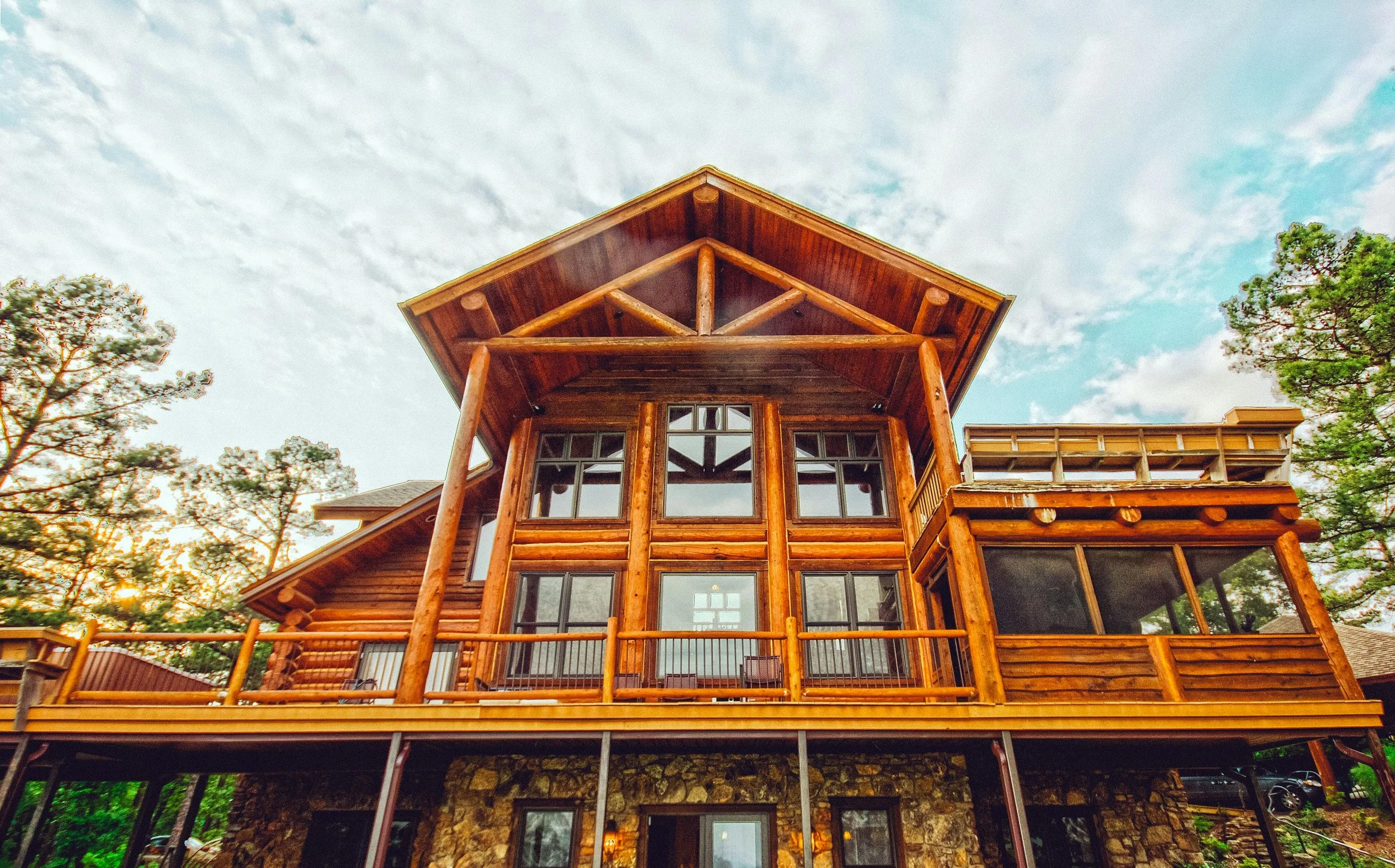 Log cabin in South Surrey, showcasing a vibrant and even finish by professional exterior staining services, enhancing outdoor living space in White Rock and Vancouver.