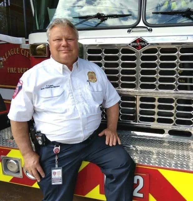 Tommy Cones in uniform with a League City fire engine