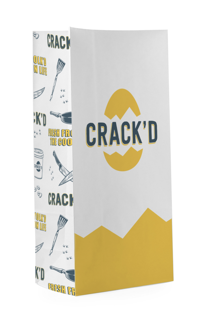 Packaging box with the brand name 'CRACK'D' and a cracked egg design, featuring yellow and gray colors.