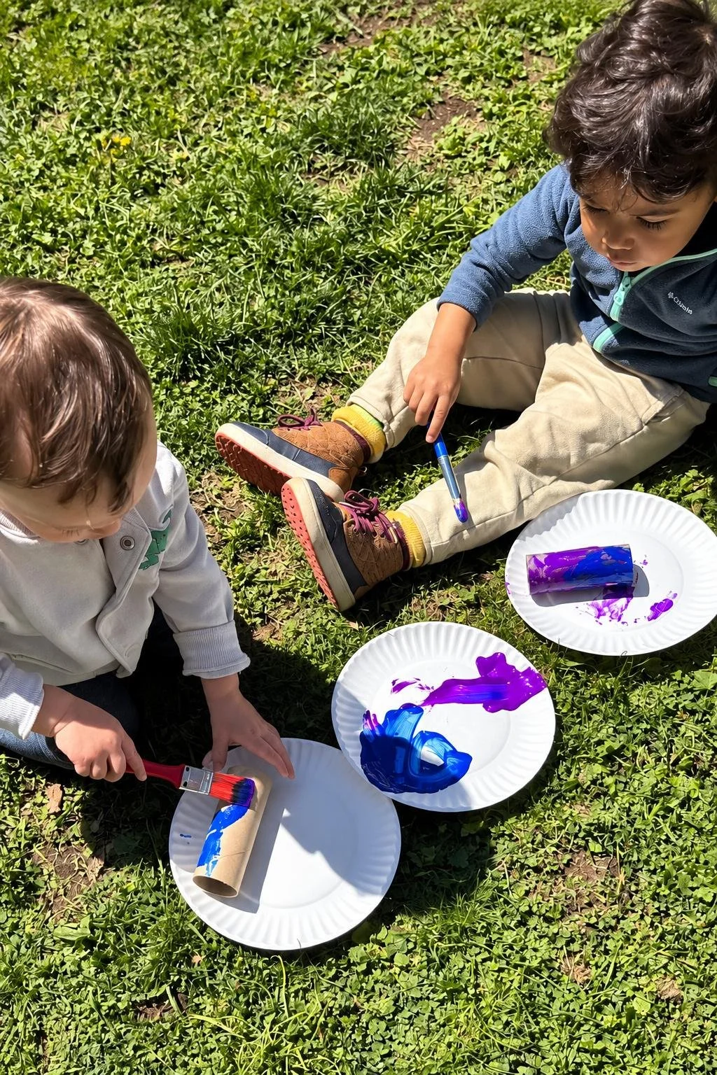 Two children painting outside at the little learning center in Norwalk, CT.