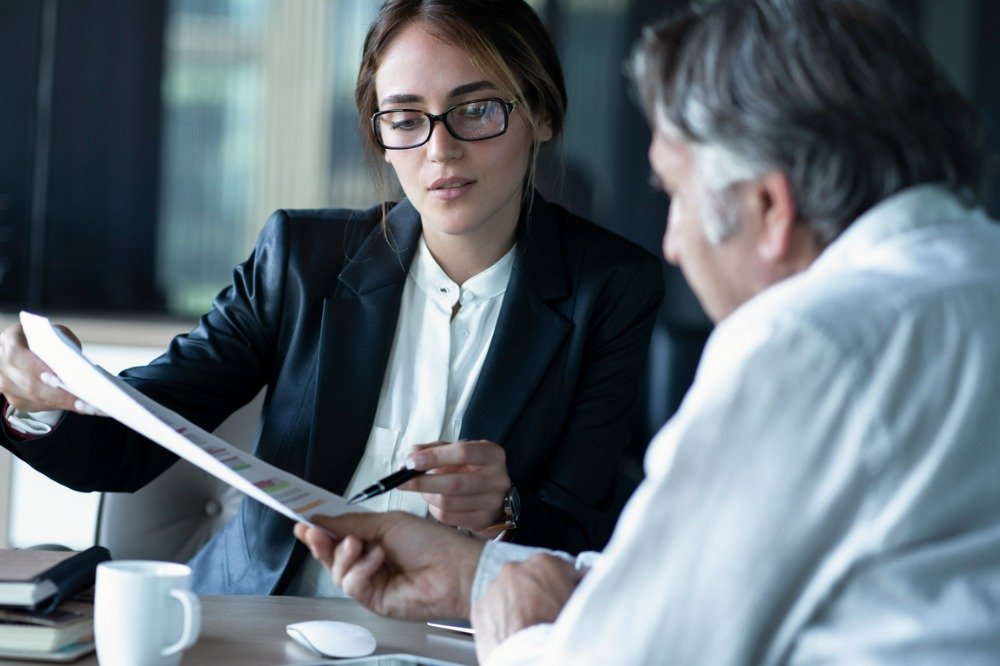 Private investigator discussing case information with a client during a confidential consultaion.