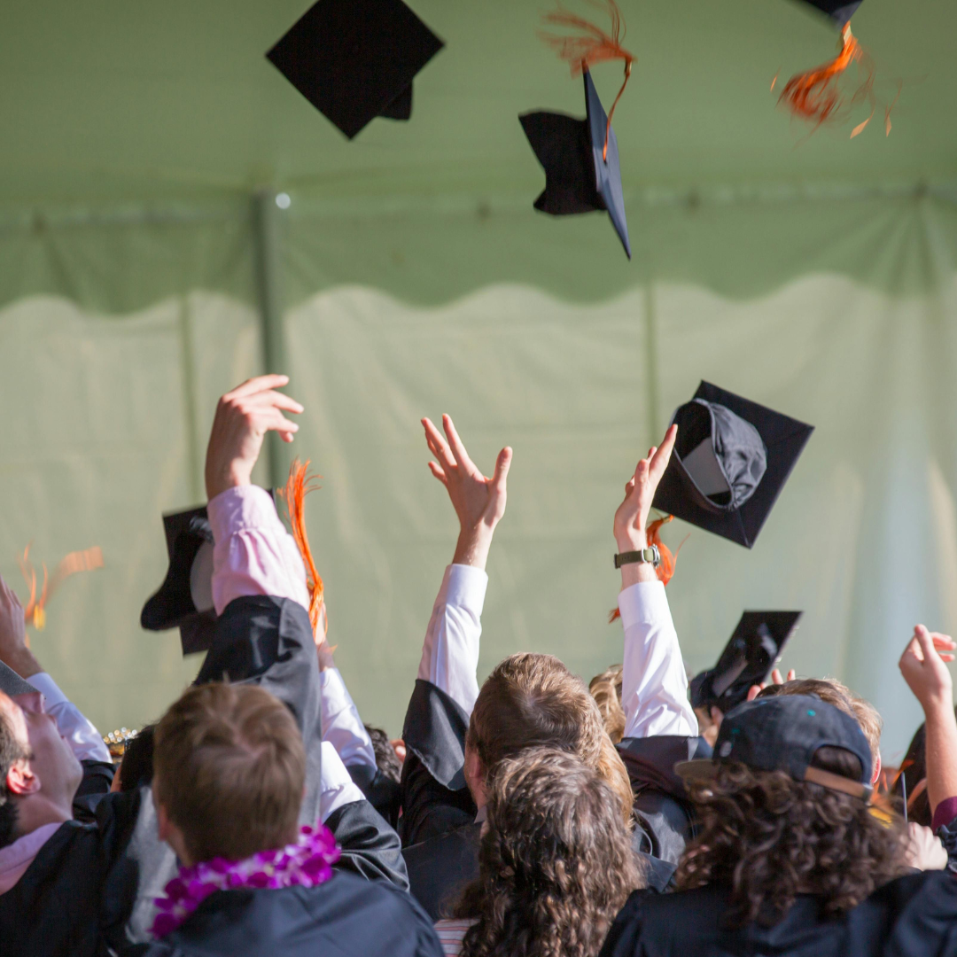 Graduates tossing their caps in the air at commencement