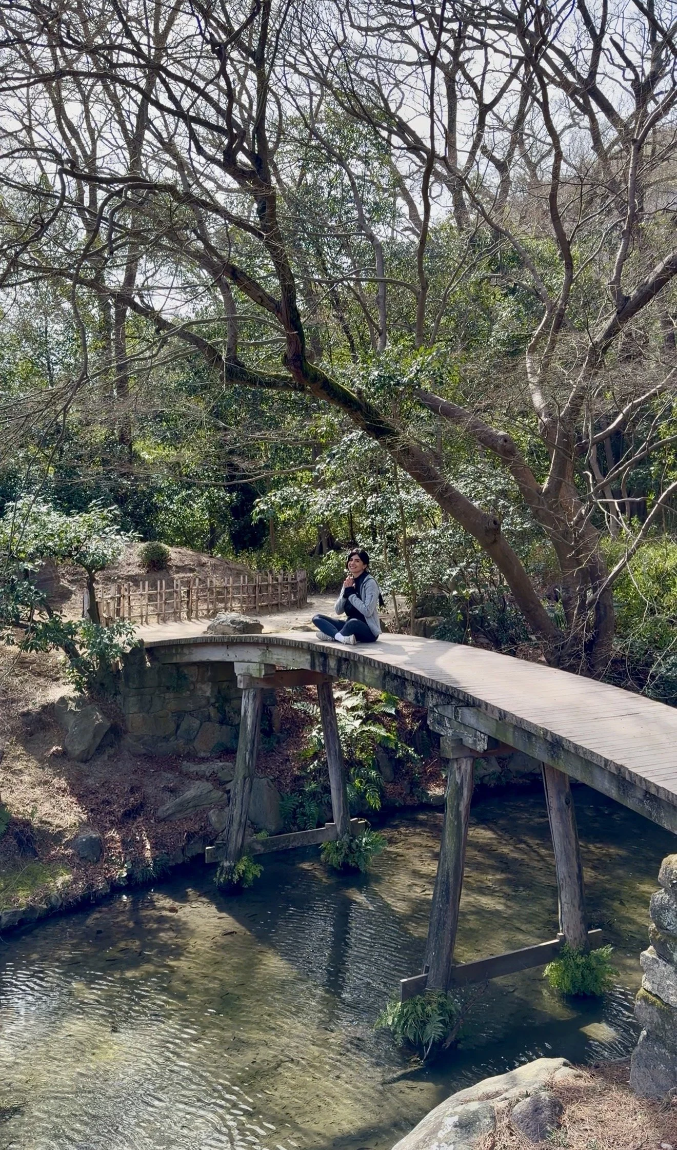 Woman meditating peacefully in nature, representing mindfulness, somatic therapy, nervous system regulation, and trauma-informed emotional healing in a calming therapy approach