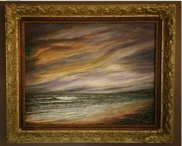 Oil painting of a sunset over the ocean, framed with an ornate gold frame.