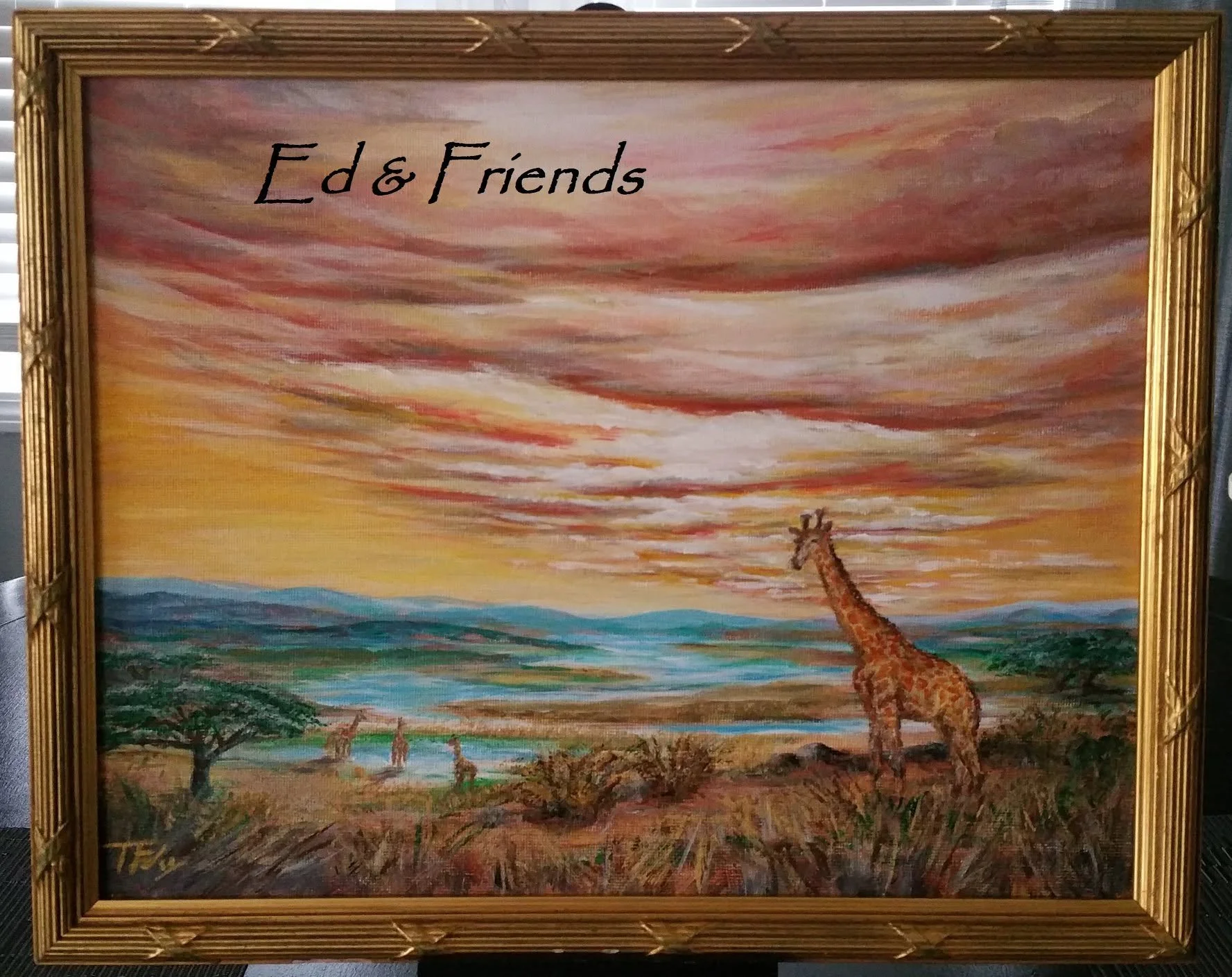 Painting of a savanna scene with a giraffe, trees, and a colorful sky at sunset, framed in gold.