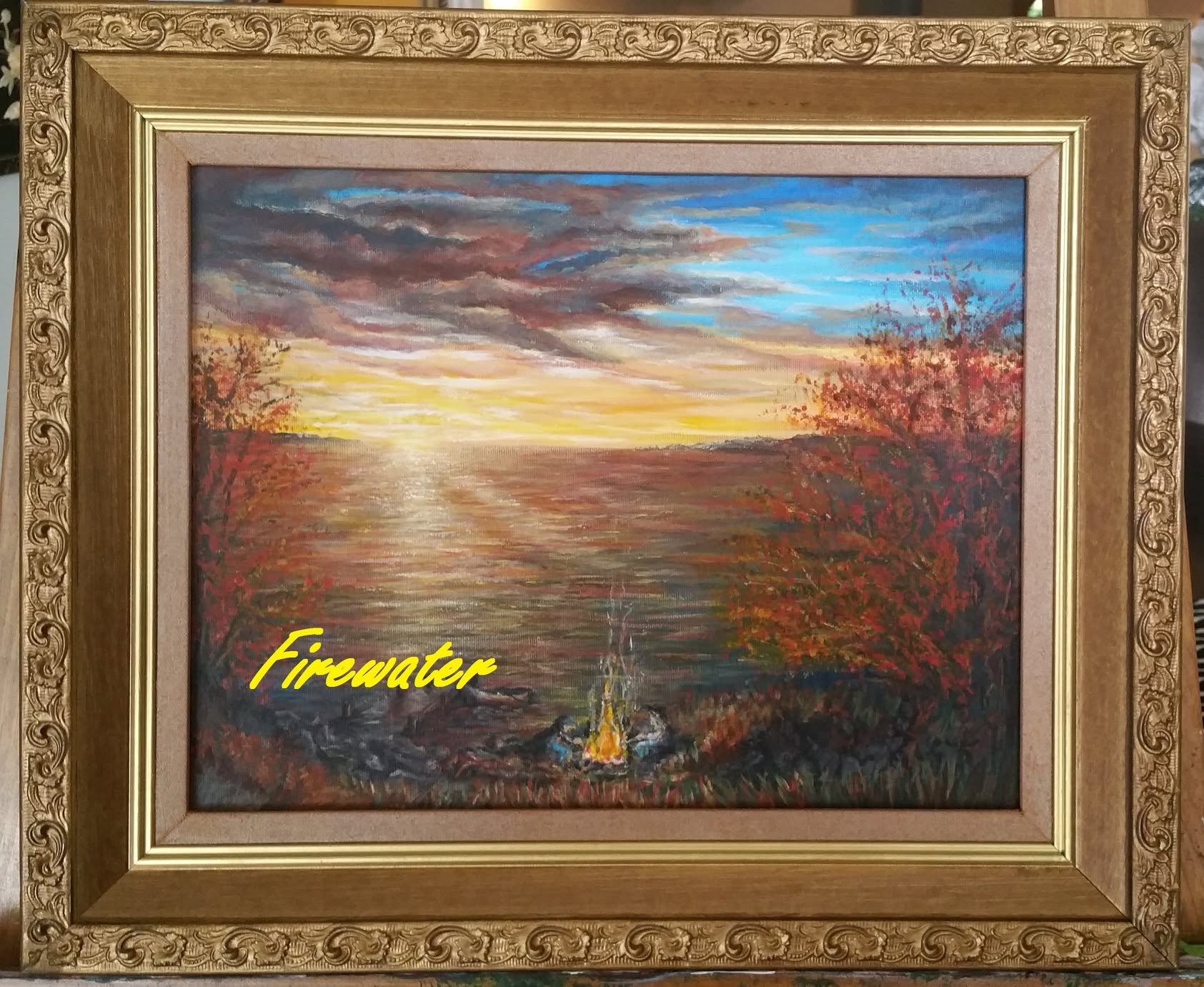 An oil painting of a sunset over water with a campfire and a boat in the foreground, and trees with autumn leaves on the sides. The word "Firewater" is written in yellow text at the bottom left corner.
