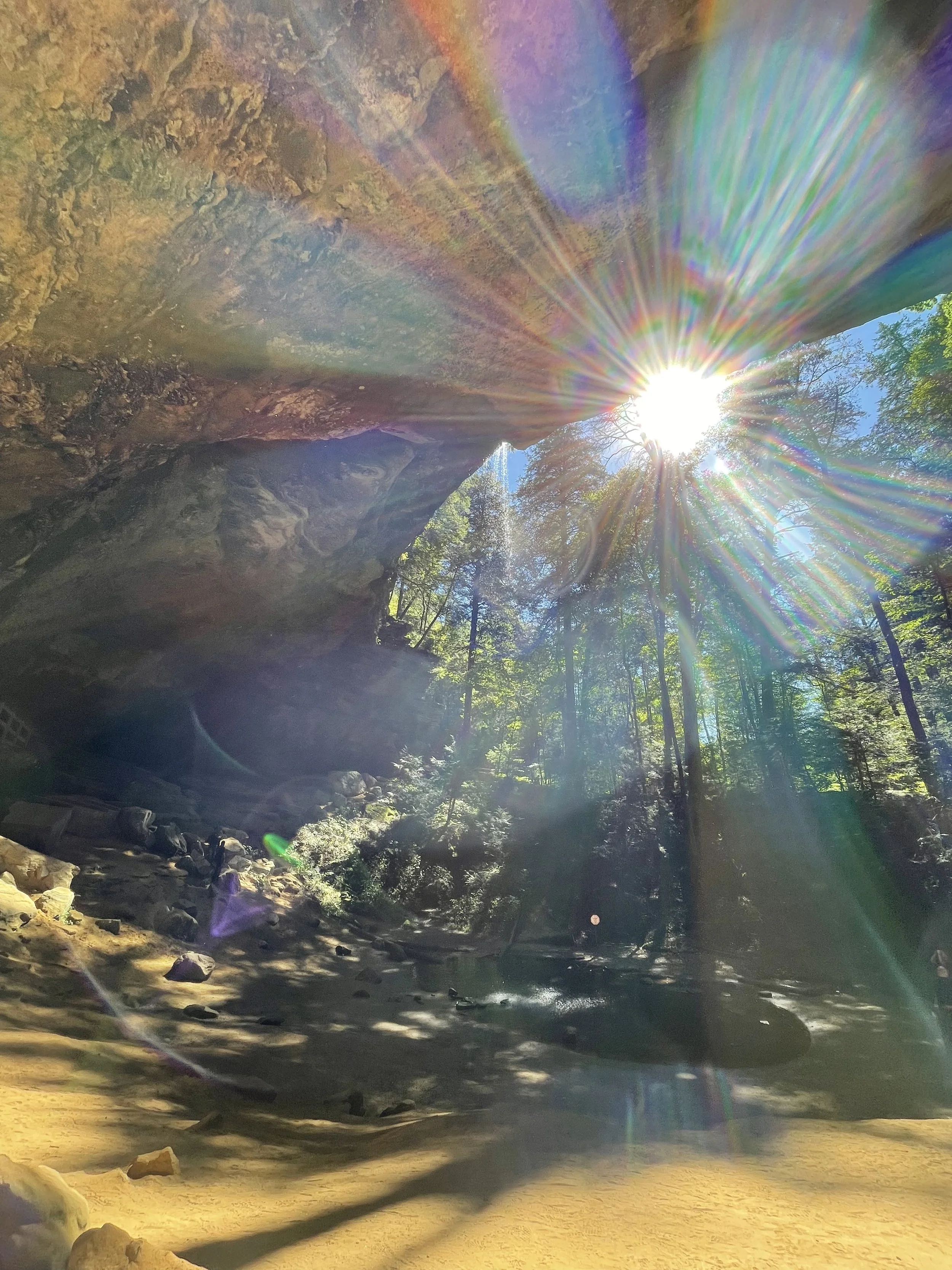 photo of Ash Cave in Hocking Hills, Ohio with lens flare from bright sunlight