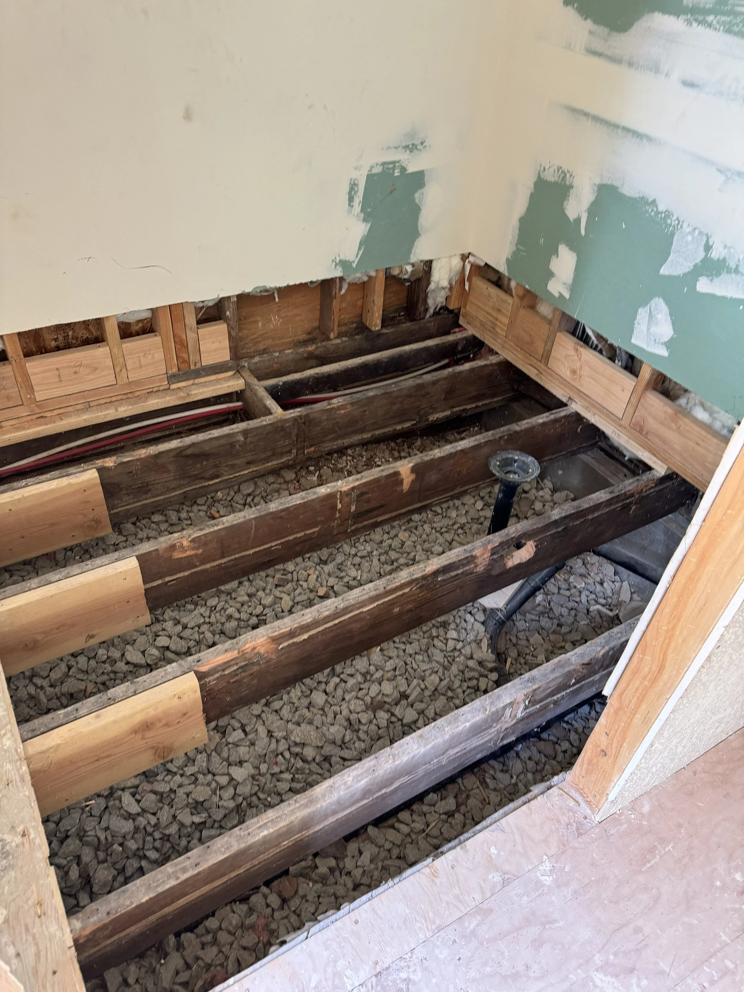 Walk-in shower floor opened for framing and plumbing work