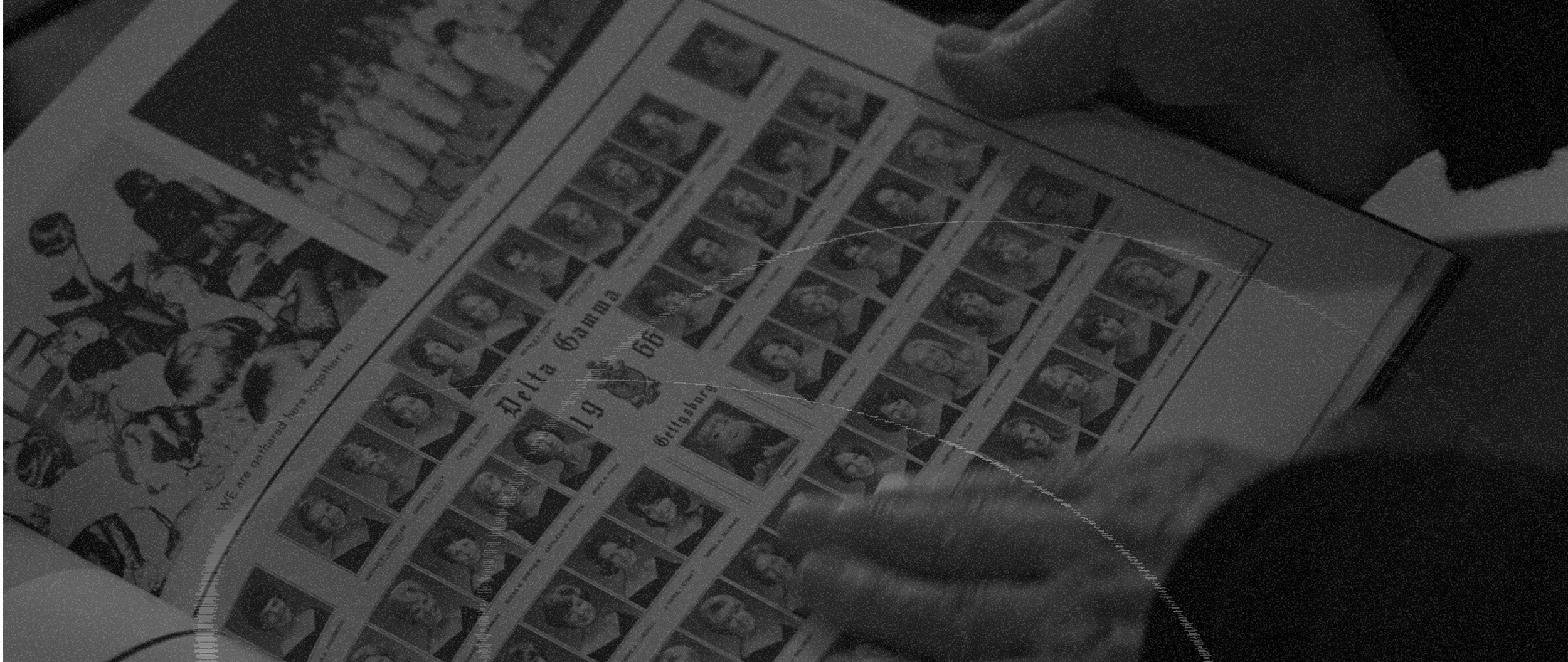 Close-up of a hand holding a sheet of personalized postage stamps with images of a religious figure, with a background showing more stamps and possibly other printed material.