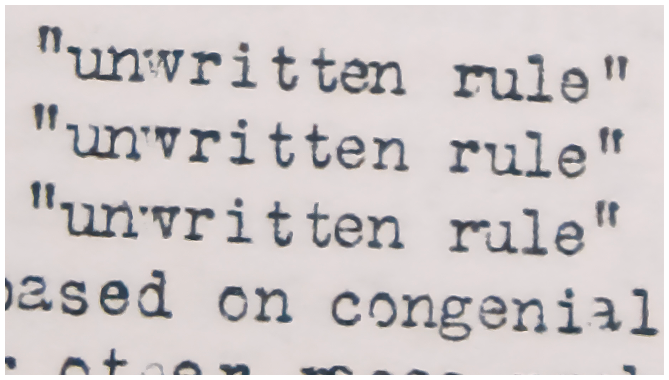 Close-up of a printed text that repeats the phrases "unwritten rule" and "written rule" in quotation marks.