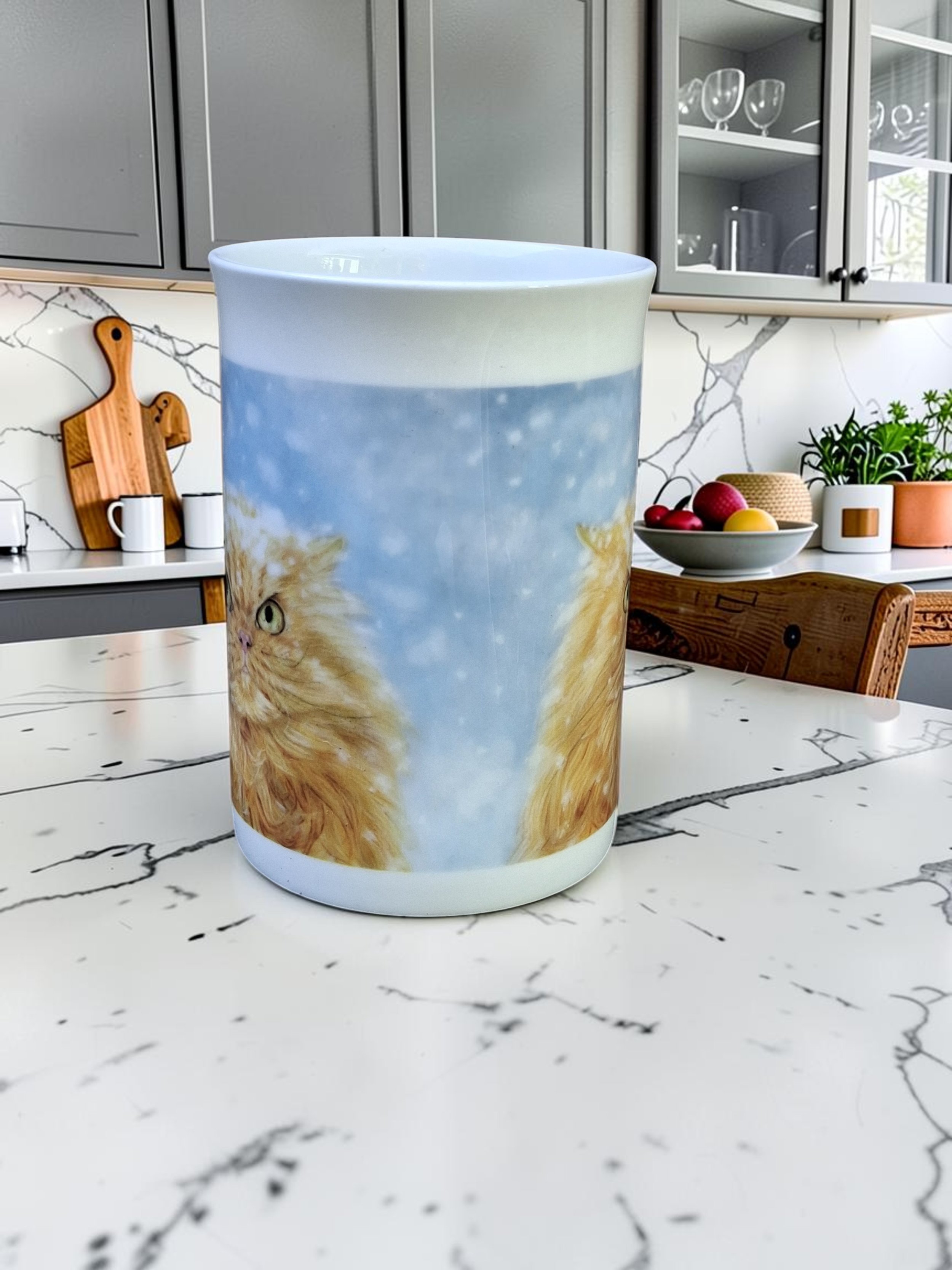 grumpy ginger cat artwork printed onto china mug placed on white marble kitchen worktop