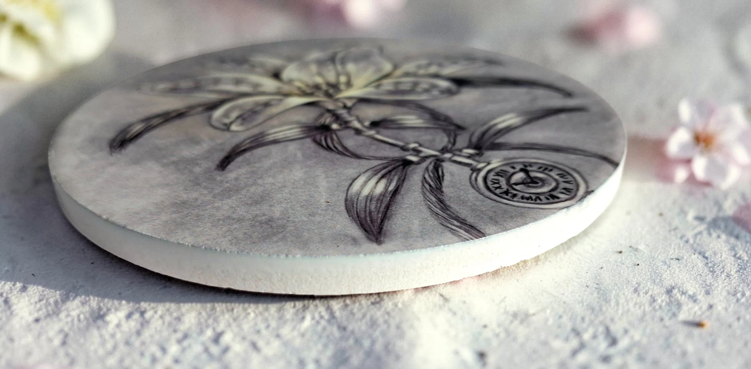 round ceramic coaster, flat lay, side view, features hand drawn lily flower done in a steampunk style
