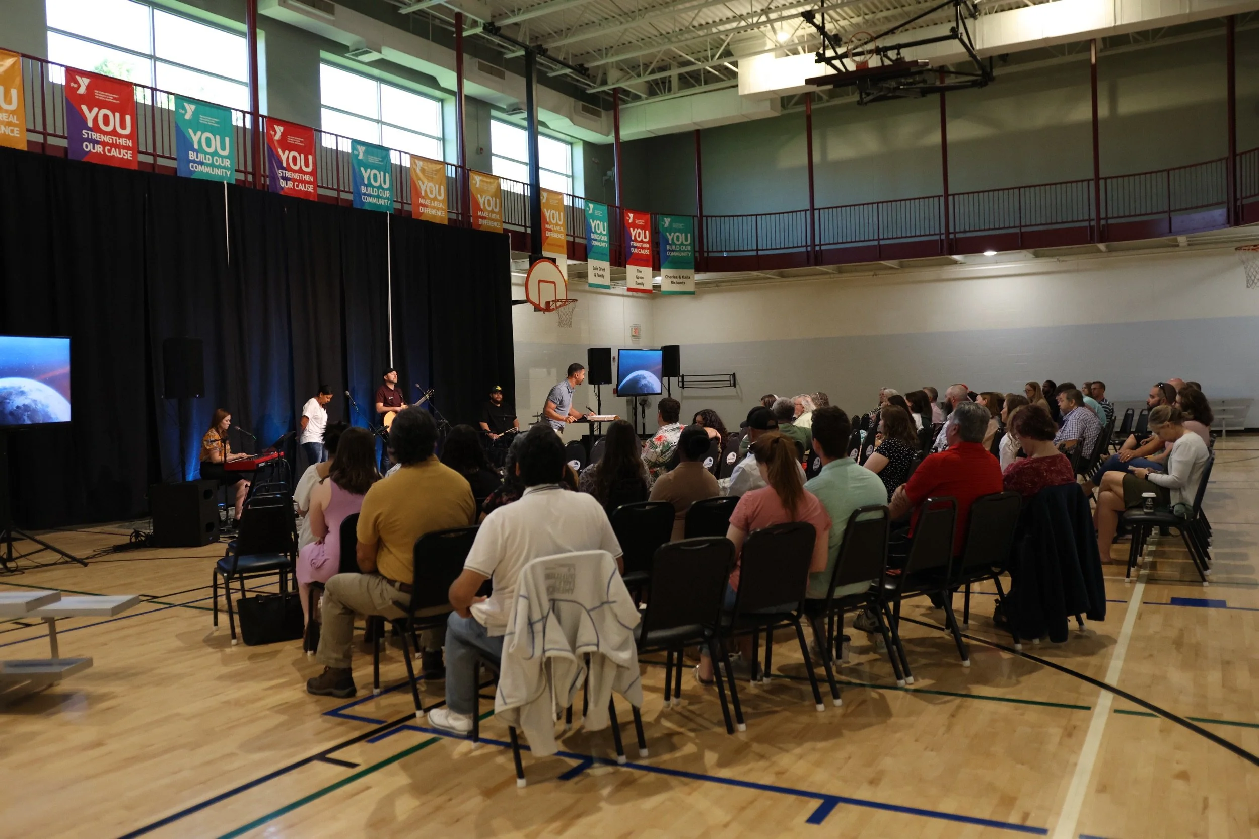 The Living Hope Church family gathered for worship, with the band leading from the front of the room.