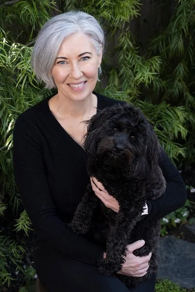 Vanessa Inn holding her dog Ash outdoors