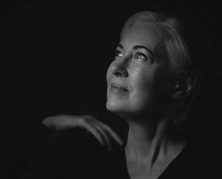 Black-and-white profile portrait of Vanessa Inn looking upward with a gentle smile