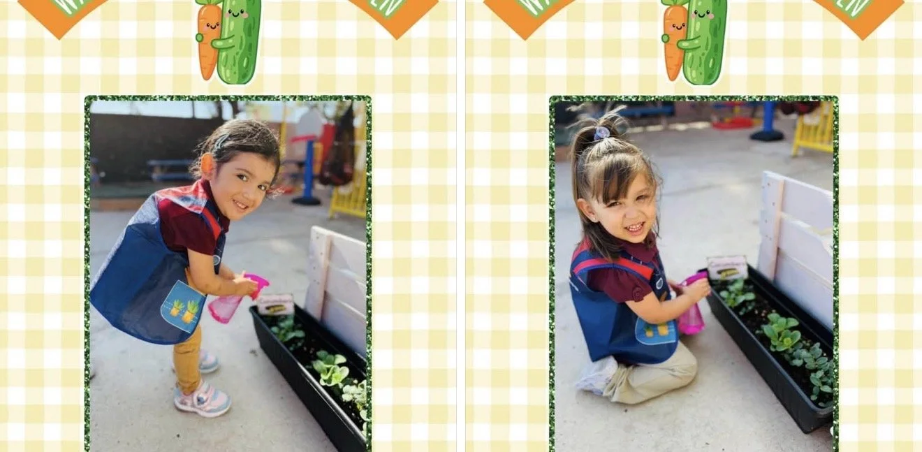Two children, a girl with dark hair in a ponytail and a girl with curly hair, are playing with a rectangular garden bed filled with green plants. The girl is standing and leaning over the garden bed, holding a pink watering can. The girl is kneeling 