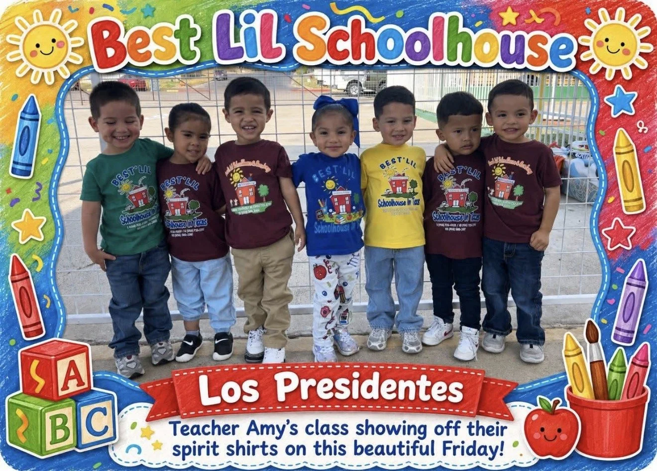 A group of seven young children standing in a row at school, smiling, wearing colorful spirit shirts with a schoolhouse graphic, at a schoolyard with a fence and parked cars in the background. The picture has a bright, colorful border with crayons, a