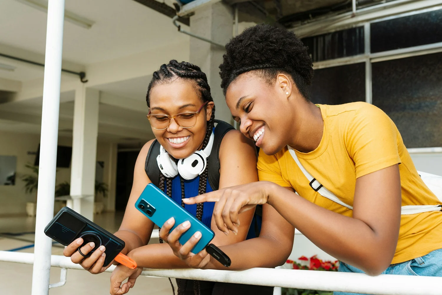 Two renters smiling over a phone together