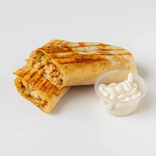 Grilled chicken wrap with a side of sour cream in a clear cup.