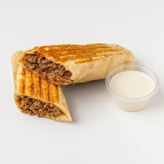Quesadilla with ground beef and a side of white sauce or sour cream in a small clear container.