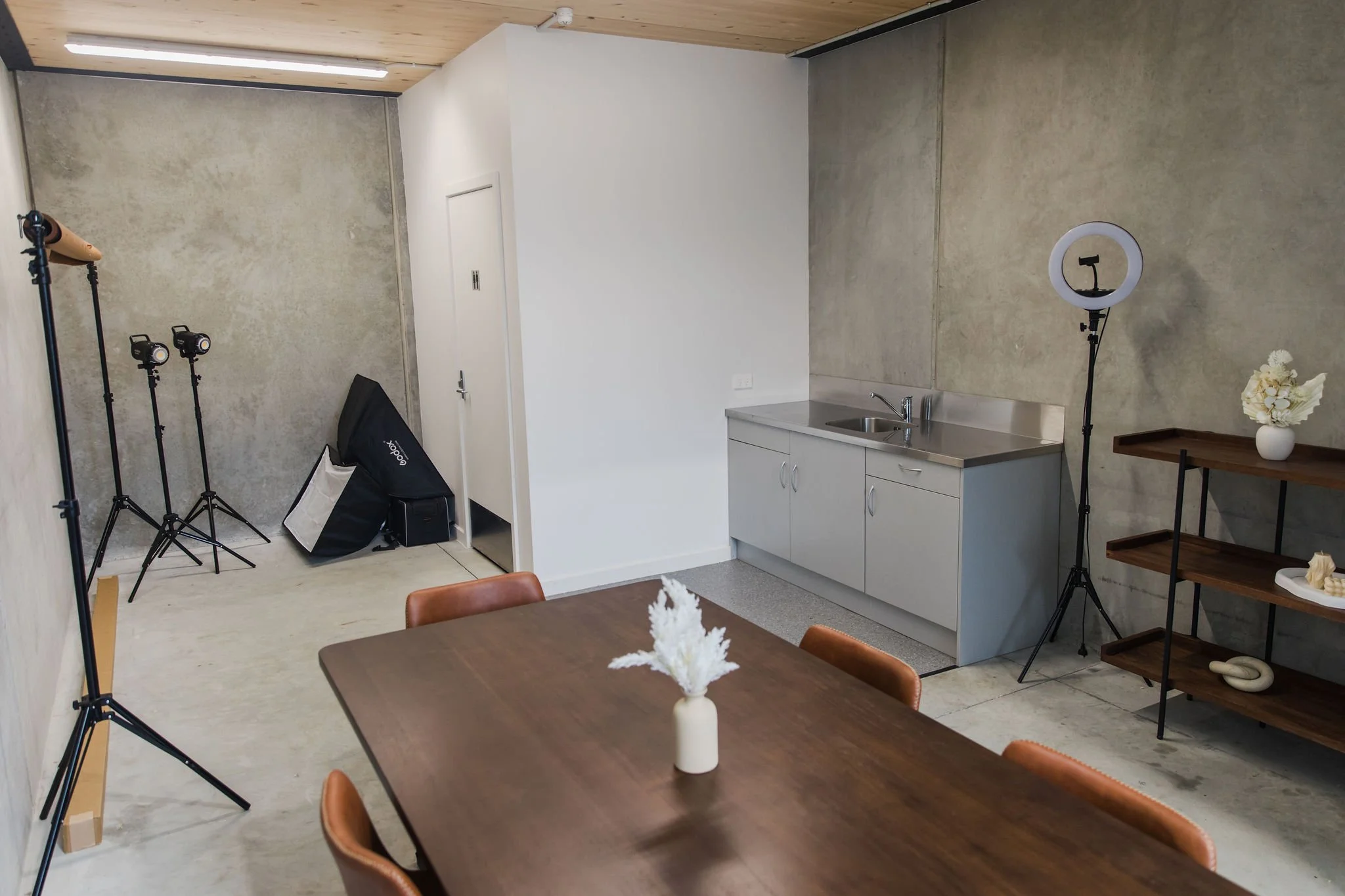 Props, a ring light and a stainless kitchenette bench, handy for flat lays and food or product content.