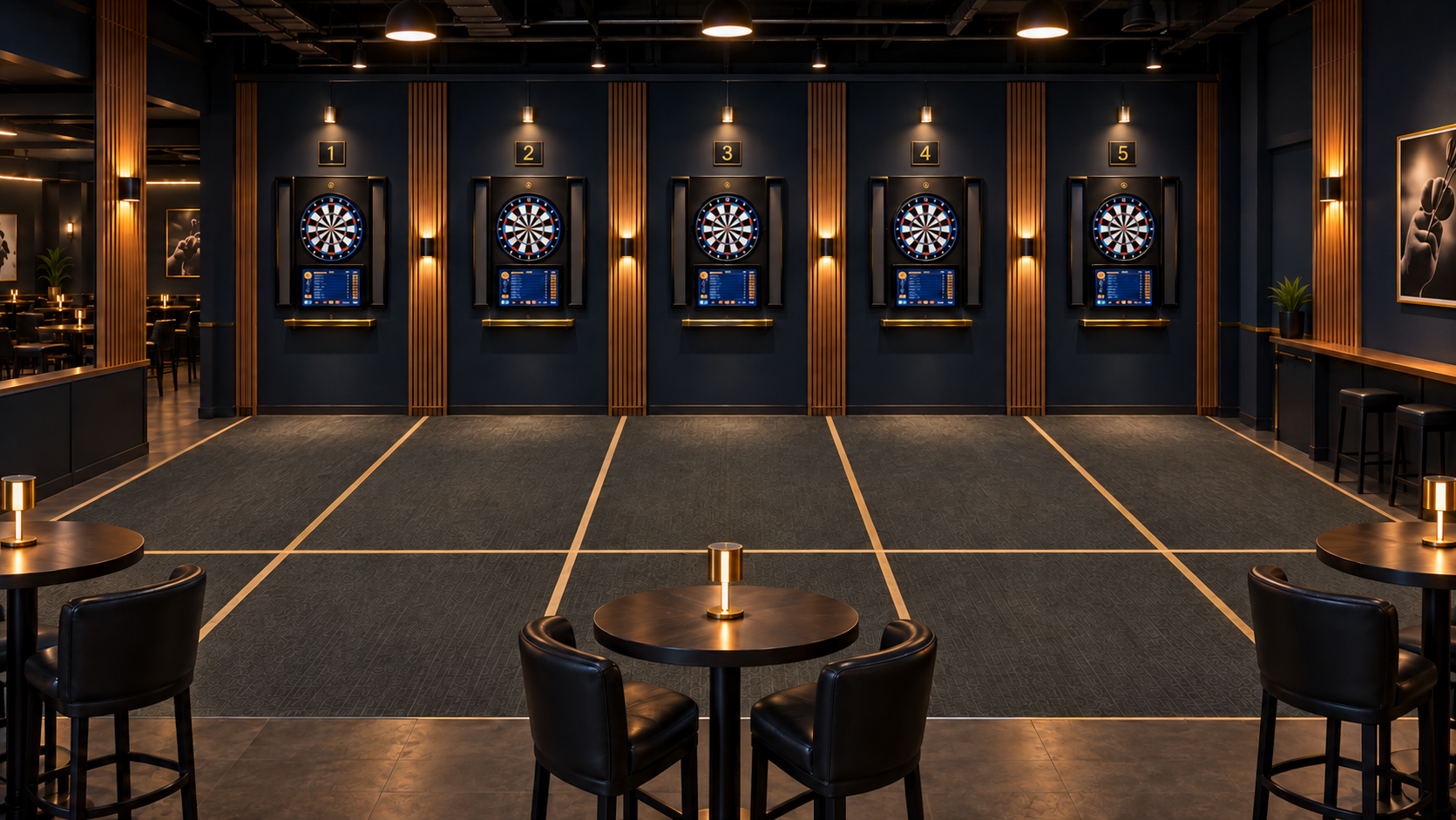 An indoor darts lounge with five electronic dartboards mounted on a navy blue wall, each numbered from 1 to 5, with digital score displays below. The space has a dark ceiling with ambient lighting and wooden accents, and there are tables with chairs and small lamps in the foreground and to the side.